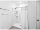 This clean bathroom features a walk-in shower with a white shower curtain and chrome hardware at 266 Caryota Ct, New Smyrna Beach, FL 32168