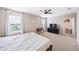 Bright bedroom offers plush carpet, a ceiling fan, and an attached walk-in closet at 266 Caryota Ct, New Smyrna Beach, FL 32168