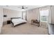 Spacious bedroom boasts natural light, neutral decor, and plush carpet for a tranquil retreat at 266 Caryota Ct, New Smyrna Beach, FL 32168
