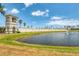 Picturesque entrance to the community featuring a pond, fountain, and elegant stone signage at 266 Caryota Ct, New Smyrna Beach, FL 32168
