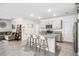 Modern kitchen featuring gray cabinets, granite countertops, stainless steel appliances, and island seating at 266 Caryota Ct, New Smyrna Beach, FL 32168