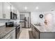 Well-equipped kitchen featuring stainless steel appliances, granite countertops, and white cabinetry at 266 Caryota Ct, New Smyrna Beach, FL 32168