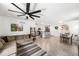 Open-concept living area with a sectional sofa, dining space, and modern kitchen, perfect for entertaining at 266 Caryota Ct, New Smyrna Beach, FL 32168