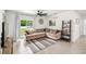 Cozy living room with a comfortable sectional sofa, tile flooring, and sliding glass doors to the backyard at 266 Caryota Ct, New Smyrna Beach, FL 32168