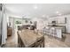 Open-concept living space featuring tile floors, a dining area, and a kitchen with bar seating at 266 Caryota Ct, New Smyrna Beach, FL 32168
