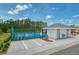 Community pickleball courts with blue surface, parking, restrooms, and surrounding greenery at 266 Caryota Ct, New Smyrna Beach, FL 32168