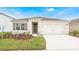 Charming single-story home with a well-manicured lawn and an attached two-car garage at 2670 Trinidad Rd, Haines City, FL 33844