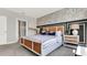 Stylish bedroom with an accent wall, modern bed frame, and bedside tables with elegant lamps and decor at 2705 Trinidad Rd, Haines City, FL 33844