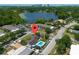 Stunning aerial view of a home with a pool, lush greenery, and lake views in a desirable neighborhood at 2801 Plaza Terrace Dr, Orlando, FL 32803