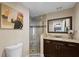 Stylish bathroom featuring a glass shower, granite vanity, and unique artwork at 2801 Plaza Terrace Dr, Orlando, FL 32803