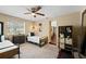 Neutral-toned bedroom with twin beds, ceiling fan, and doorway to another room at 2801 Plaza Terrace Dr, Orlando, FL 32803