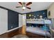 Playful bedroom with bunk beds, a ceiling fan, and a fun, outer-space-themed mural at 2801 Plaza Terrace Dr, Orlando, FL 32803