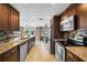 Modern kitchen with granite countertops, stainless steel appliances, and backyard pool view at 2801 Plaza Terrace Dr, Orlando, FL 32803
