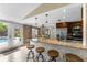 Eat-in kitchen with granite counters, stainless steel appliances, pendant lighting, and backyard pool view at 2801 Plaza Terrace Dr, Orlando, FL 32803