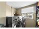 Bright laundry room with modern washer and dryer, plus storage space at 2801 Plaza Terrace Dr, Orlando, FL 32803