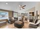 Spacious living room featuring tile floors, a ceiling fan, and a view of the kitchen and backyard pool at 2801 Plaza Terrace Dr, Orlando, FL 32803