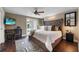 Comfortable main bedroom featuring a ceiling fan, desk, backyard pool view, and soft decor at 2801 Plaza Terrace Dr, Orlando, FL 32803