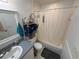 Clean bathroom featuring a shower-tub combo and functional storage at 307 Hollingshead Loop, Davenport, FL 33896