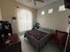 Cozy bedroom featuring a ceiling fan, natural light, and tile floors at 307 Hollingshead Loop, Davenport, FL 33896