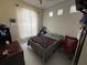 A bedroom with white tiled floors, a ceiling fan, and a queen sized bed at 307 Hollingshead Loop, Davenport, FL 33896