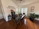A dining room with hardwood floors, a ceiling fan, and a black table with six chairs at 307 Hollingshead Loop, Davenport, FL 33896