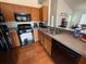 Kitchen featuring wooden cabinets, stainless steel appliances, and laminate countertops at 307 Hollingshead Loop, Davenport, FL 33896