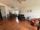 A open floor living space with hardwood floors, ceiling fans, and dining room at 307 Hollingshead Loop, Davenport, FL 33896