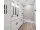 Bathroom features a double vanity, quartz countertop, and a tiled walk-in shower at 3072 Sw 168Th Loop, Ocala, FL 34473