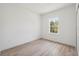 A bright bedroom with light wood-look floors and a sunny window at 3072 Sw 168Th Loop, Ocala, FL 34473