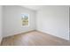 An airy bedroom with natural light, showcasing wood-look floors and a clean, simple design at 3072 Sw 168Th Loop, Ocala, FL 34473