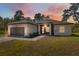 Inviting single-story home featuring a two car garage, modern design, and well-maintained landscaping at sunset at 3072 Sw 168Th Loop, Ocala, FL 34473
