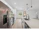 Contemporary kitchen featuring a central island with quartz countertops, undermount sink, and stainless steel appliances at 3072 Sw 168Th Loop, Ocala, FL 34473