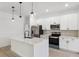 Bright kitchen features a quartz island, stainless steel appliances, and modern pendant lighting at 3072 Sw 168Th Loop, Ocala, FL 34473