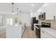 Beautiful kitchen features an island, stainless steel appliances, and white cabinets at 3072 Sw 168Th Loop, Ocala, FL 34473