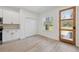 Bright room with a kitchenette featuring white cabinetry, stainless steel appliances, and a window view at 3072 Sw 168Th Loop, Ocala, FL 34473