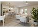 Open-concept living space with modern furniture, a kitchen island, and a dining area, ideal for entertaining guests at 3072 Sw 168Th Loop, Ocala, FL 34473