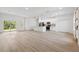 Bright, open living space with large windows, a kitchen, and neutral-toned flooring at 3072 Sw 168Th Loop, Ocala, FL 34473