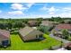 Aerial view of the property showcasing the backyard, surrounding homes, and lush greenery at 3078 Mandolin Dr, Kissimmee, FL 34744