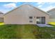 Image of the backyard with a sliding door and a spacious grassy area at 3078 Mandolin Dr, Kissimmee, FL 34744