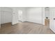 Bright bedroom with hardwood floors, natural light, closet, and an entry way to the bathroom at 3078 Mandolin Dr, Kissimmee, FL 34744