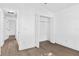 Bright bedroom with hardwood floors, closet with bi-fold doors, and an entry to another room at 3078 Mandolin Dr, Kissimmee, FL 34744