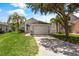 Classic single-Gathering home boasting a two-car garage and well-maintained lawn, showcasing suburban charm at 3078 Mandolin Dr, Kissimmee, FL 34744