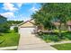 Charming single Gathering home with a well-maintained lawn and a large shade tree in the front yard at 3078 Mandolin Dr, Kissimmee, FL 34744