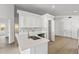 Bright kitchen boasts stainless steel appliances, an island with quartz countertops, and white cabinets at 3078 Mandolin Dr, Kissimmee, FL 34744