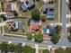 An aerial view of several backyard pools, various rooftops, and neatly lined neighborhood streets at 3216 White Blossom Ln, Clermont, FL 34711