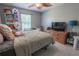 Bright bedroom featuring a ceiling fan, window, neutral walls, and wood-look flooring at 3216 White Blossom Ln, Clermont, FL 34711
