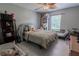 Cozy bedroom with a ceiling fan, window, neutral walls, and wood-look flooring at 3216 White Blossom Ln, Clermont, FL 34711