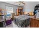 Bedroom with a ceiling fan, natural light from the window, and a U-Haul moving box at 3216 White Blossom Ln, Clermont, FL 34711