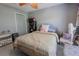 Bedroom with a window and closet featuring modern gray flooring and a ceiling fan at 3216 White Blossom Ln, Clermont, FL 34711