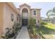 Charming front entrance with a pathway leading to the door and garden at 3216 White Blossom Ln, Clermont, FL 34711